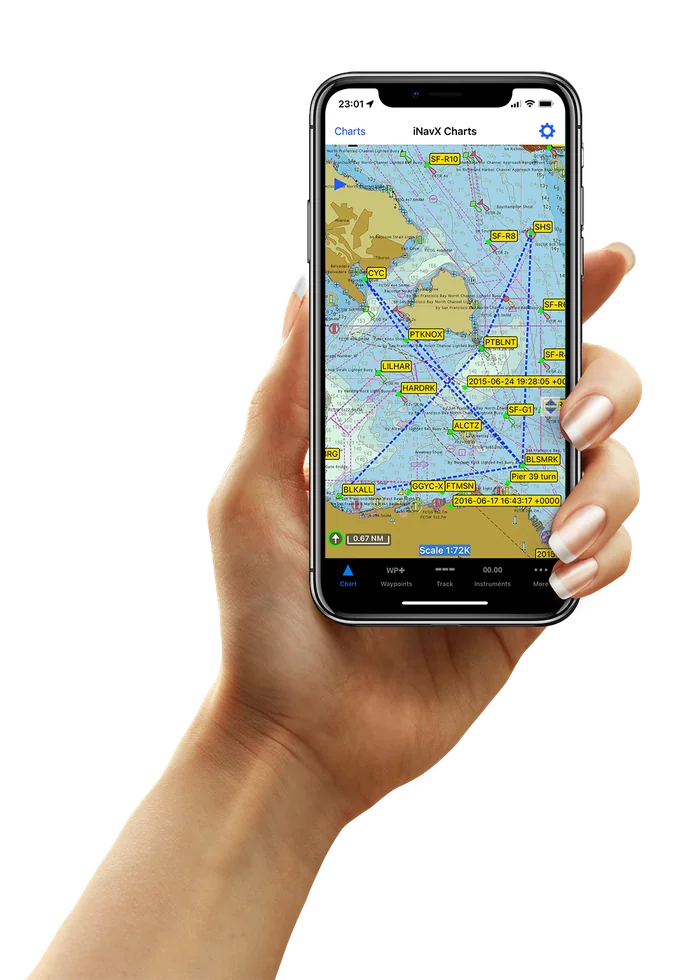 A hand holding an iPhone running iNavX, showing a detailed marine chart of San Francisco Bay with a plotted route and waypoints